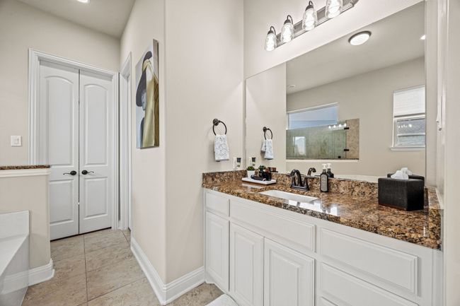 Bathroom with vanity, tile patterned floors, a shower, a bath, and baseboards | Image 16