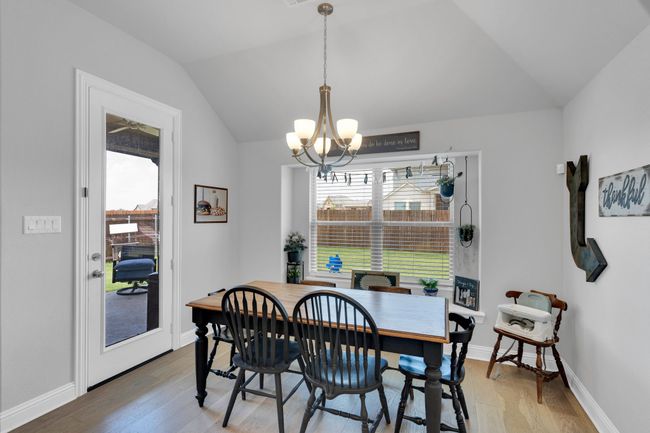 Dining area featuring light above table and chairs | Image 11