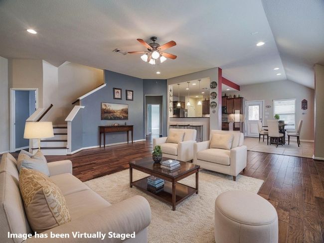 Living room with wood-type flooring, ceiling fan, stairs, recessed lighting, and lofted ceiling | Image 18