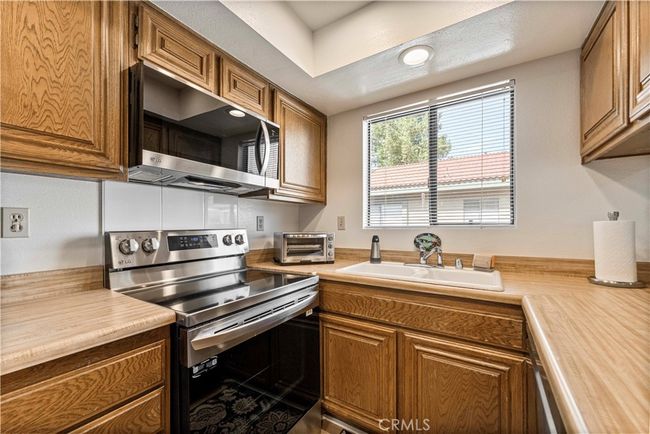 Super clean kitchen with newer stovetop range, microwave and refrigerator. | Image 10