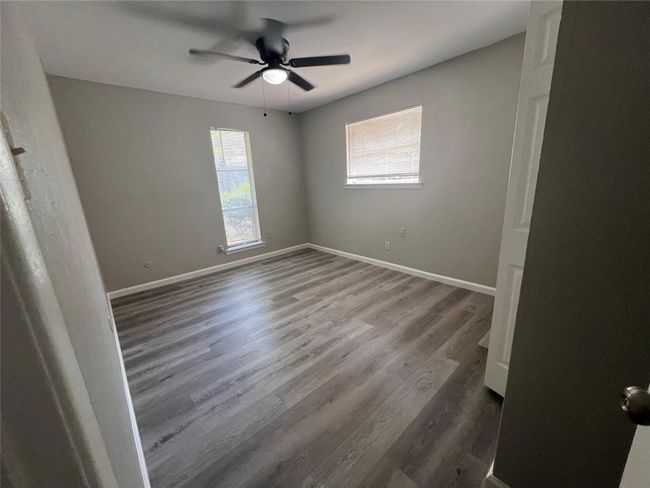 Spare room with wood finished floors and a ceiling fan | Image 13