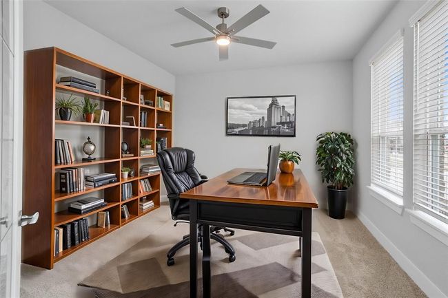 Quietly nestled in front of the home is the handsome home office! Featuring plush carpet flooring, high ceilings with ceiling fan, large windows with privacy blinds, and custom paint! | Image 5