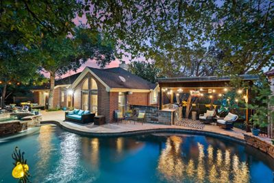 Enjoy unparalleled privacy in the backyard, where majestic live oaks provide a natural canopy and tranquil ambiance. | Image 1