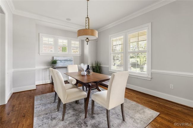 10' ceilings, 8' open casement; chair rail, designer light fixture, plantation shutters, site finished hardwood floors | Image 6