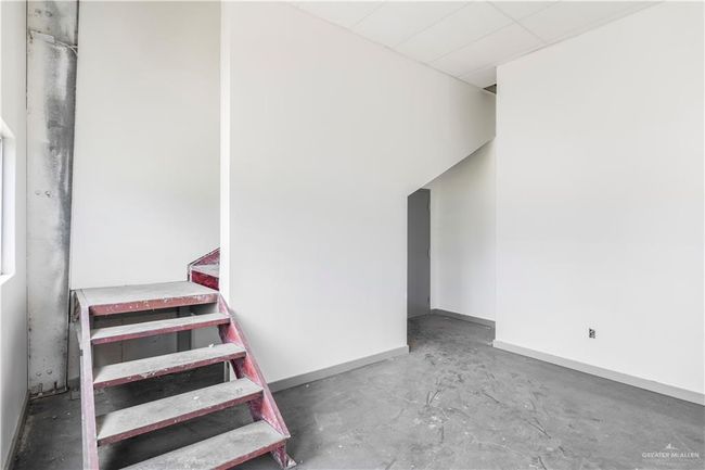 Stairway featuring unfinished concrete flooring and baseboards | Image 29