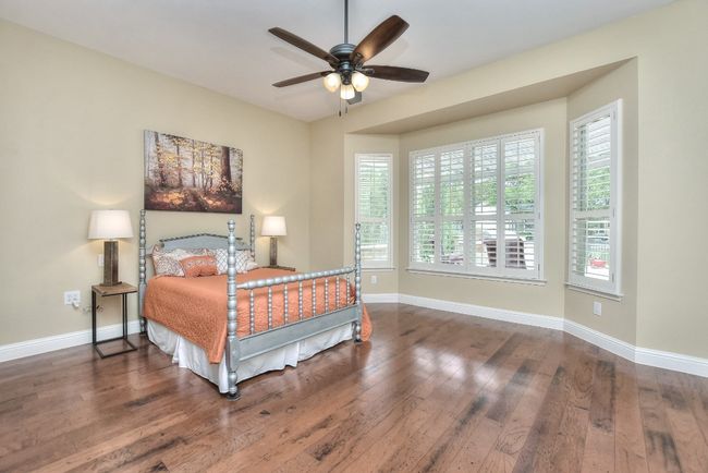 Large primary bedroom with beautiful bay window that looks out to the patio under the pergola. | Image 17