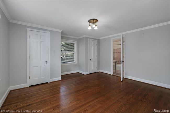 Empty room featuring ornamental molding and dark wood-style flooring | Image 23
