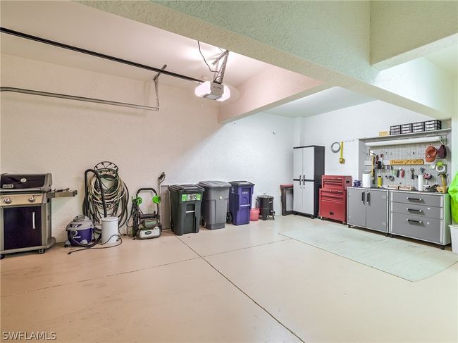 Garage featuring a workshop area and a garage door opener | Image 33