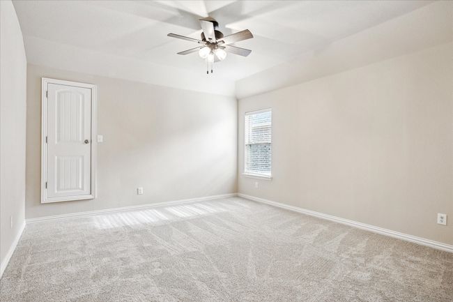 Spare room featuring ceiling fan, carpet floors, baseboards, and lofted ceiling | Image 25
