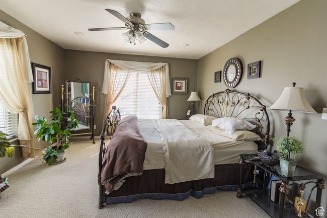 Bedroom with baseboards, a ceiling fan, and carpet floors | Image 13