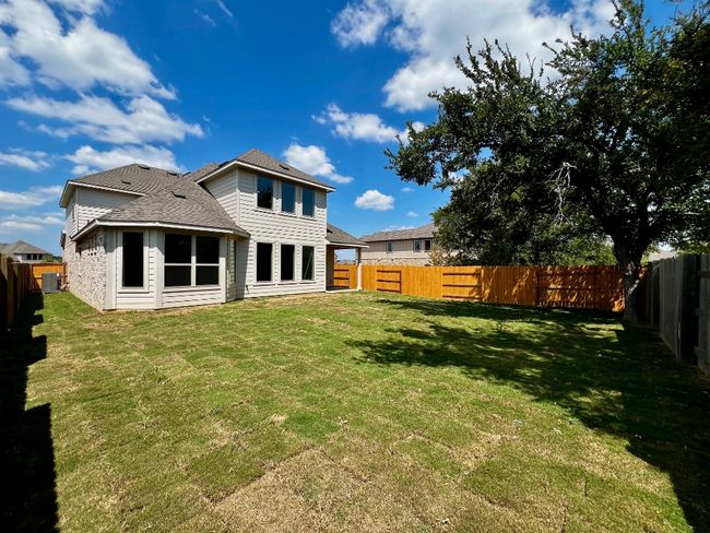 Back of property with a shingled roof and a fenced backyard | Image 22