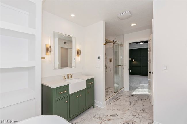 Bathroom featuring walk in shower, vanity, and tile floors | Image 43