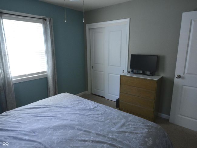 carpeted bedroom with baseboards and multiple windows | Image 21