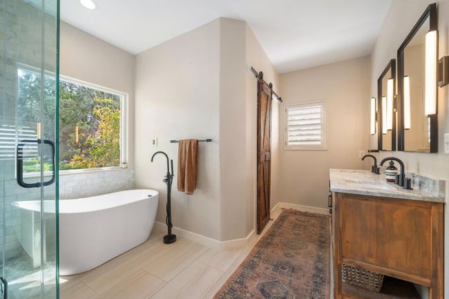 Full bath with a soaking tub, vanity, a stall shower, and baseboards | Image 19