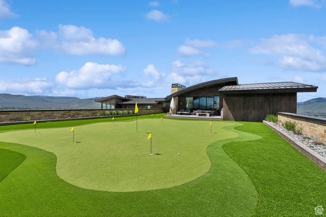 Surrounding community with an area to practice putting and a mountain view | Image 119