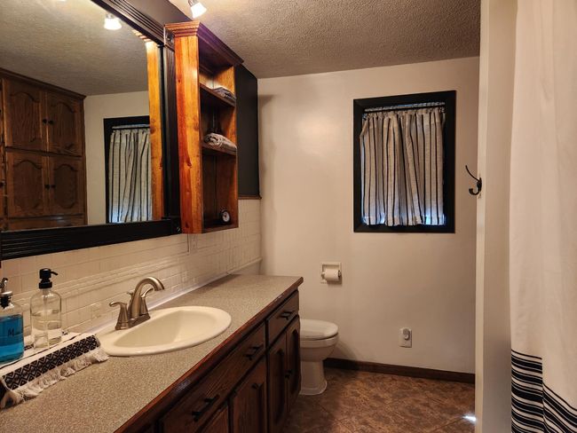 Main floor full bath boast updated tub & shower. | Image 15
