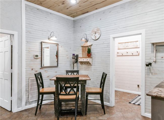 Dining space featuring wooden walls and wood ceiling | Image 6