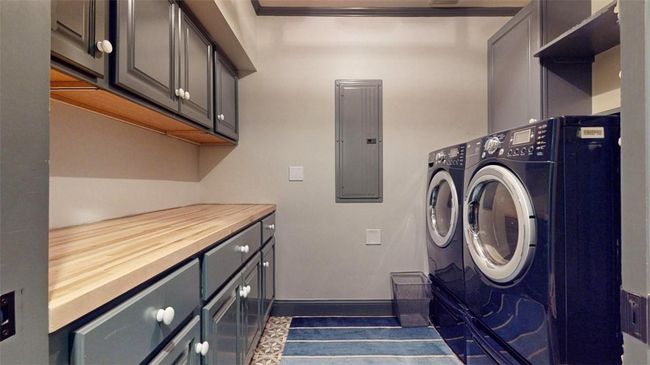 Washroom with separate washer and dryer, tile flooring, and cabinets | Image 17