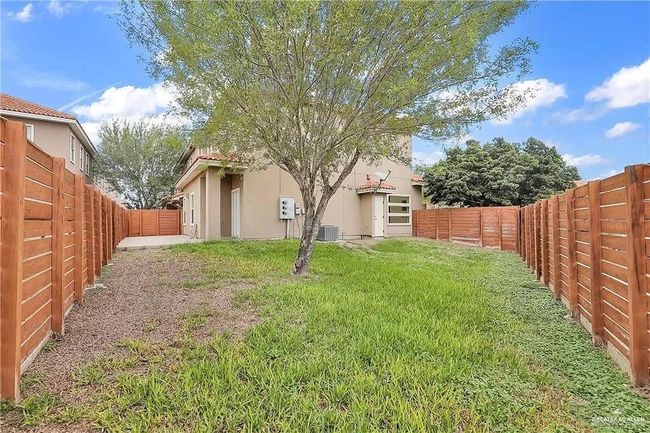 View of fenced backyard | Image 19