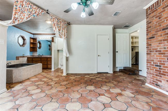 Unfurnished bedroom featuring ornamental molding, a ceiling fan, baseboards, and ensuite bath | Image 25