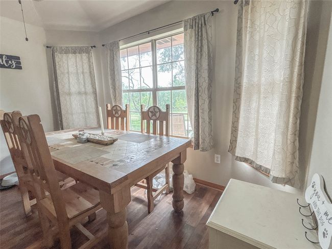 Dining space featuring baseboards and dark wood-style flooring | Image 9
