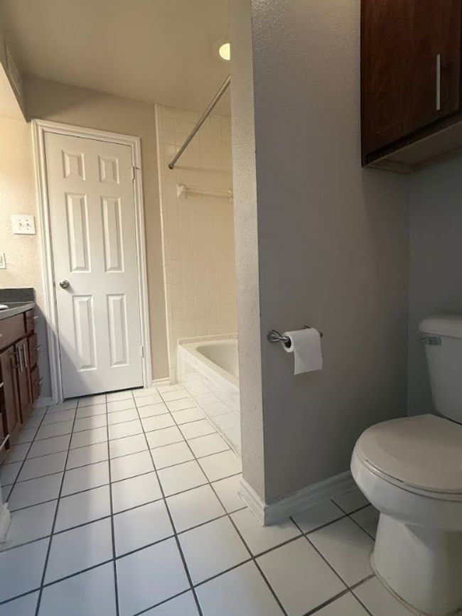 Full bath with tile patterned floors, vanity, and bathing tub / shower combination | Image 25