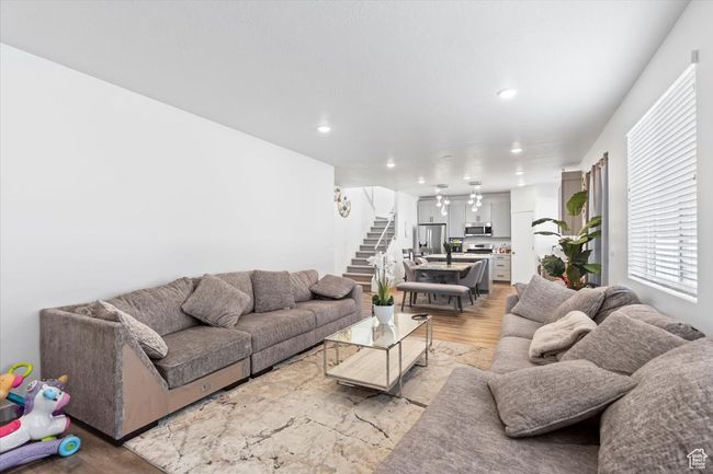 Living area featuring recessed lighting, stairs, and light wood-style flooring | Image 5