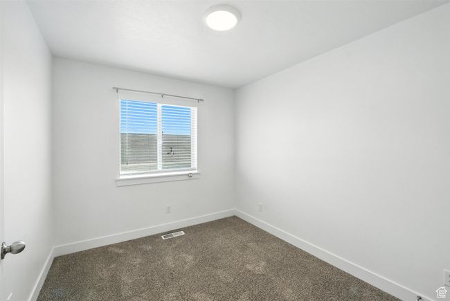 Empty room with baseboards and dark carpet | Image 14