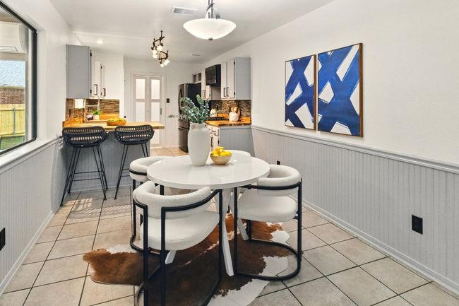Dining room is adjoined to the open kitchen area and is complete with wainscoting. Dining offers a perfect setting for both cozy meals and lively gatherings. | Image 7