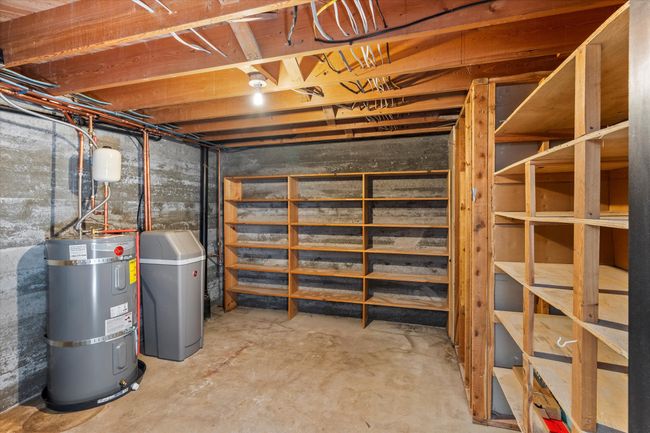 Basement with strapped water heater | Image 32