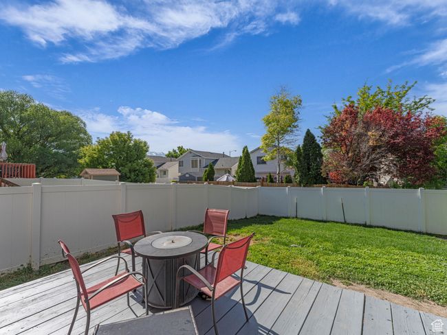 Wooden deck with outdoor dining area and a residential view | Image 37
