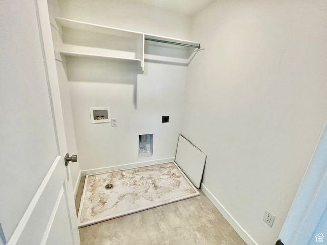 Laundry area with light wood finished floors, electric dryer hookup, and hookup for a washing machine | Image 19