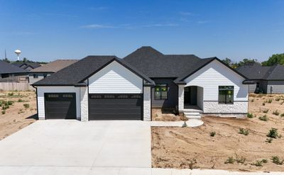 Modern farmhouse style home with a garage | Image 1