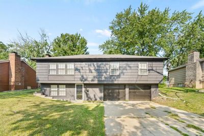 View of front of home featuring a garage and a front yard | Image 1