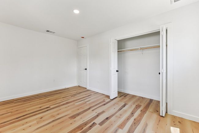 Unfurnished bedroom with recessed lighting, light wood finished floors, and a closet | Image 29