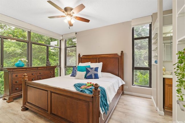 Primary bedroom w/ treetop views. | Image 10