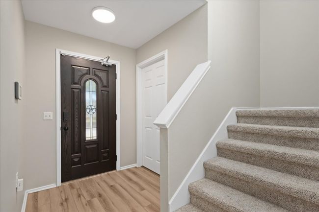 Entrance foyer featuring baseboards, wood finished floors, and stairs | Image 8