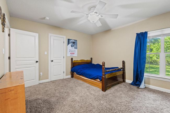 Bedroom featuring carpet, baseboards, and ceiling fan | Image 27