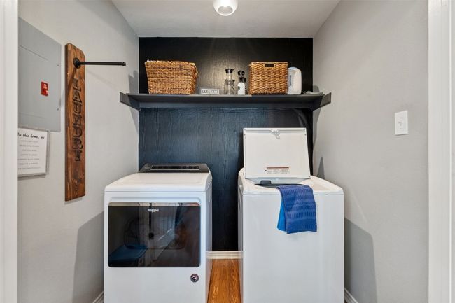 Laundry room with washing machine and dryer, wood finished floors, and laundry area | Image 14