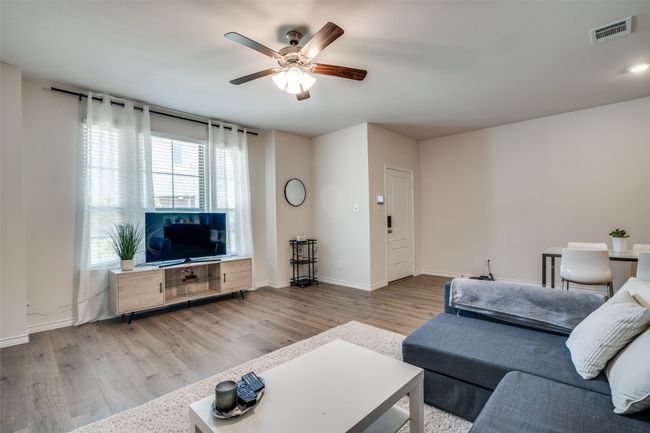 Living area featuring ceiling fan and wood finished floors | Image 5
