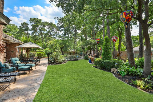 Beautifully landscaped backyard sanctuary with expansive green space. | Image 29