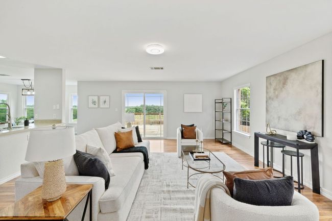 Living area with light wood-style floors and baseboards | Image 13