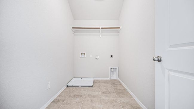 Washroom featuring hookup for an electric dryer, washer hookup, gas dryer hookup, and light tile patterned floors | Image 25