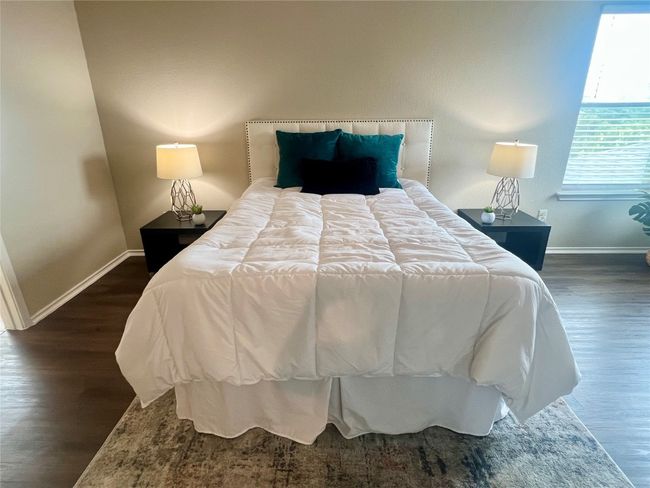 Bedroom with baseboards and wood finished floors | Image 18