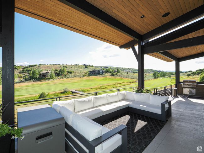 View of patio featuring an outdoor hangout area, view of golf course, and an outdoor kitchen | Image 12