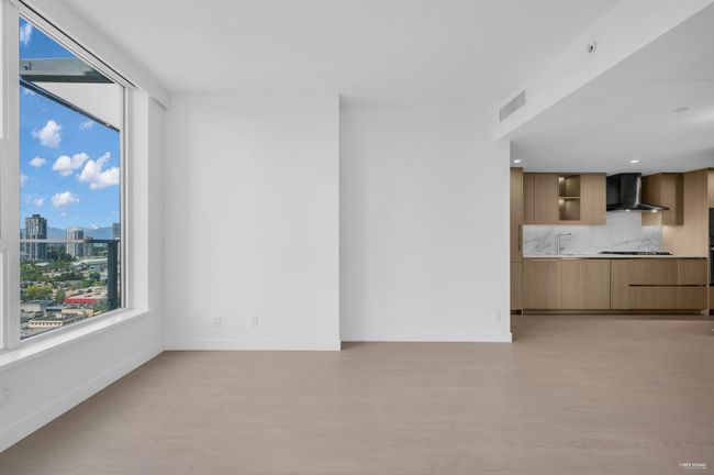 Unfurnished living room with a city view and light wood-style flooring | Image 10
