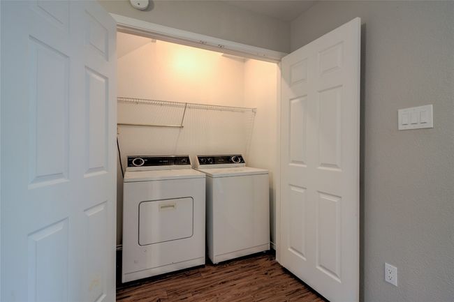 Laundry area with washer and dryer and dark wood-style flooring | Image 19