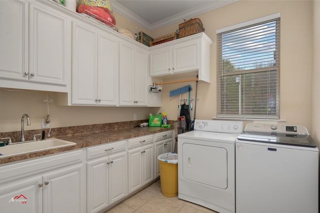 Spacious laundry room with lots of extra storage. | Image 26
