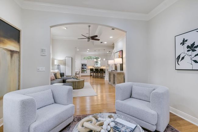 Secondary living room featuring beautiful natural light, crown molding, and plenty of entertaining space. | Image 9