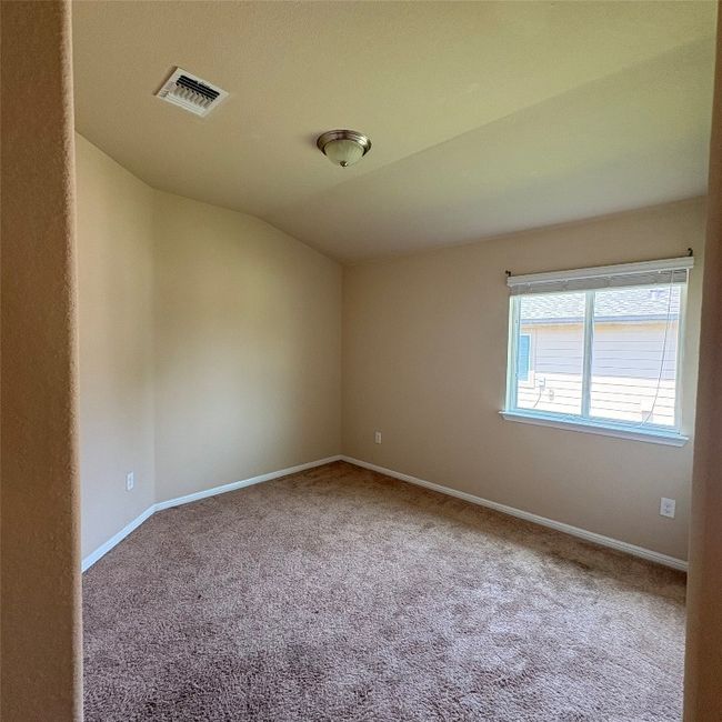 Second bedroom with lofted ceiling and carpet floors | Image 14